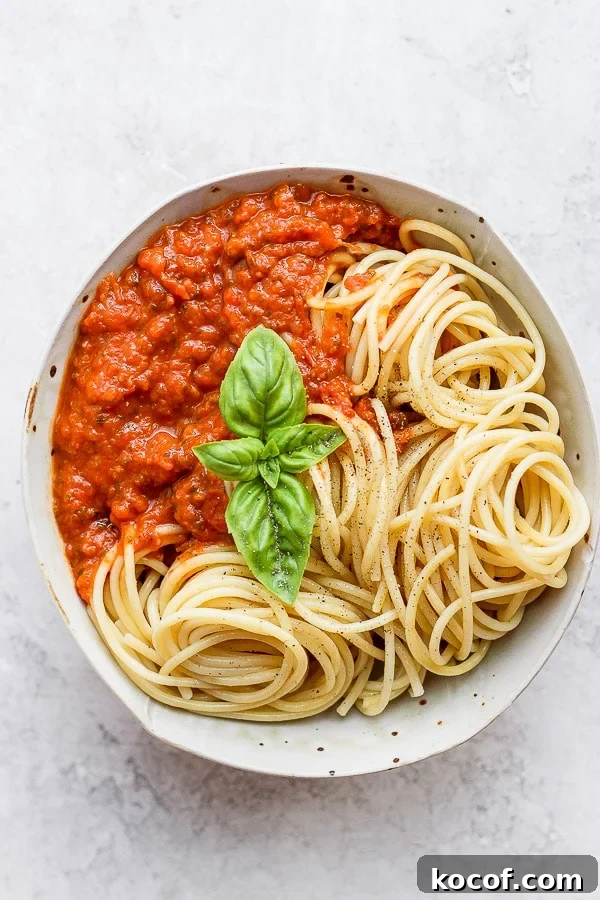 Bowl of spaghetti noodles and marinara sauce.