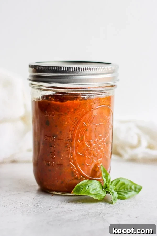 Mason jar of homemade marinara sauce.