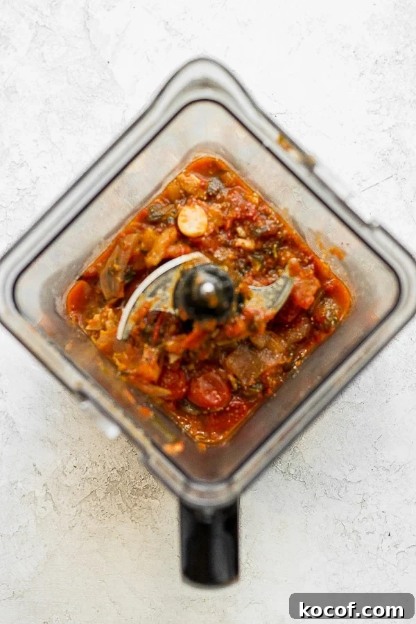 Blender with roasted tomatoes inside.