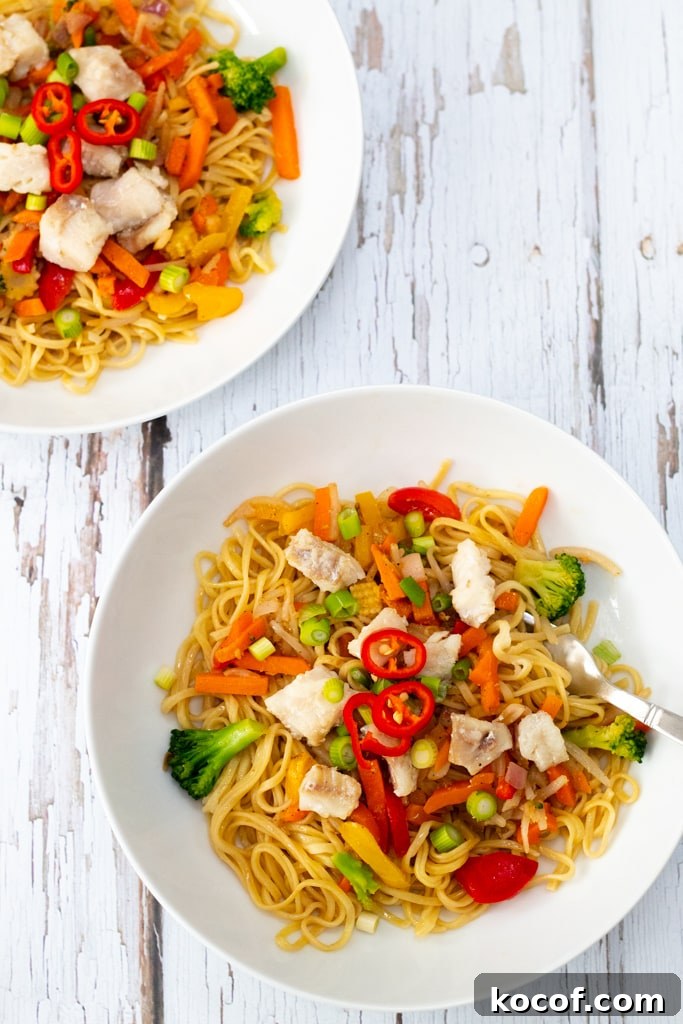 two bowls of stir fry noodles with Alaskan pollock