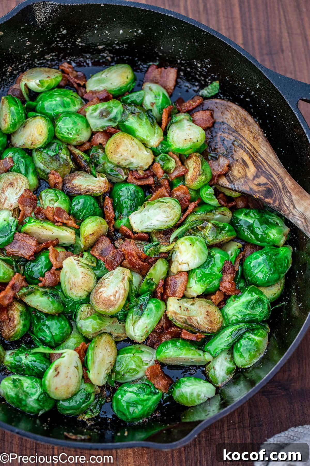 Crispy Pan-Fried Brussels Sprouts with Bacon and Garlic 2 Pan-fried Brussels sprouts with bacon in a black skillet.