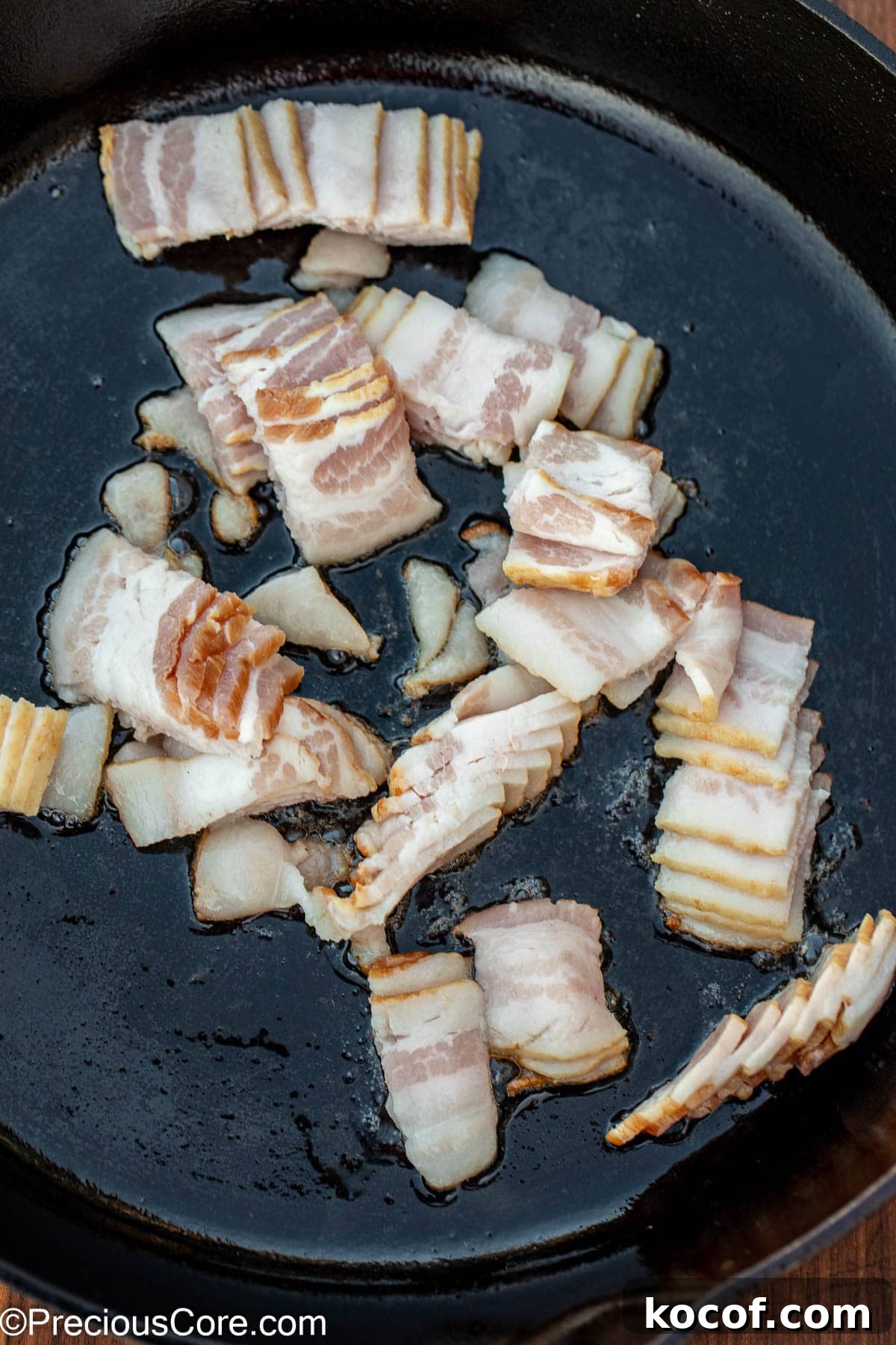 Crispy Pan-Fried Brussels Sprouts with Bacon and Garlic 6 Sliced bacon in a cast iron skillet.