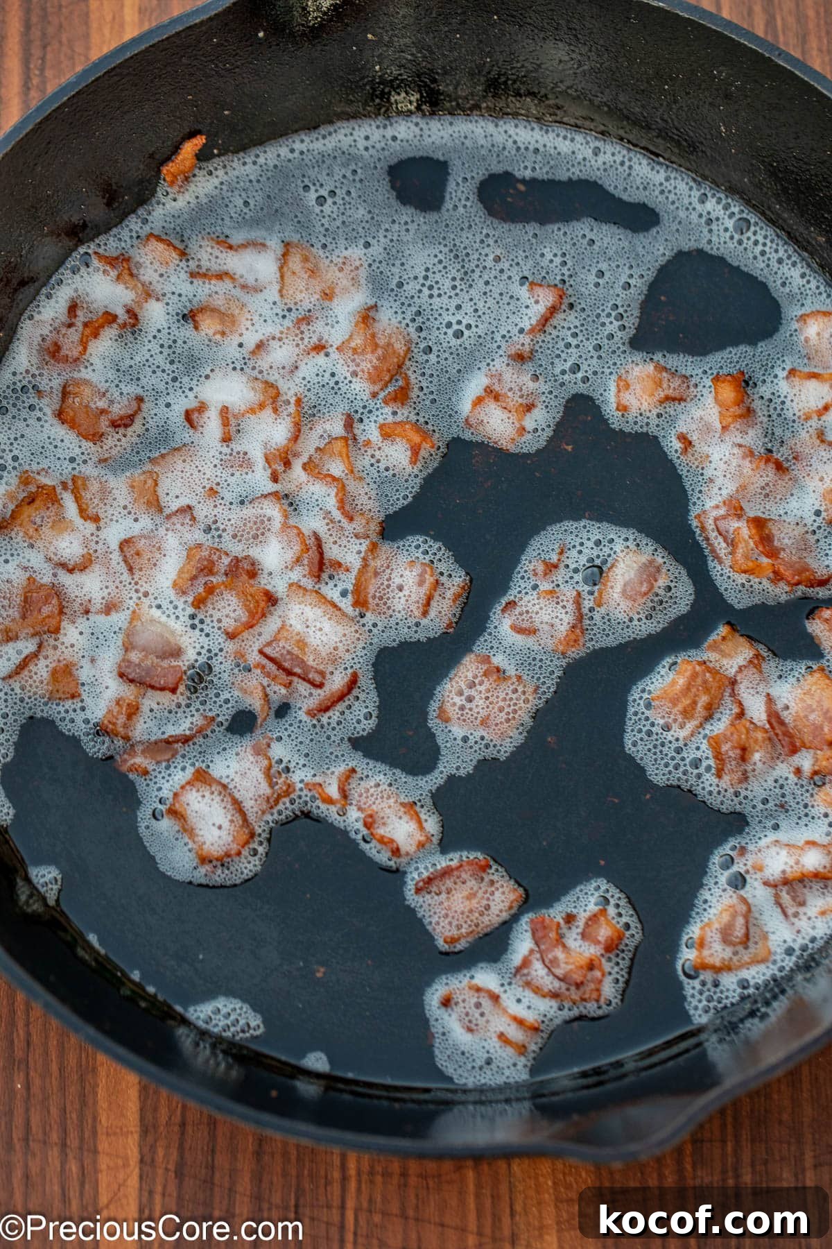 Crispy Pan-Fried Brussels Sprouts with Bacon and Garlic 7 Browned bacon bits in bacon grease in a skillet.