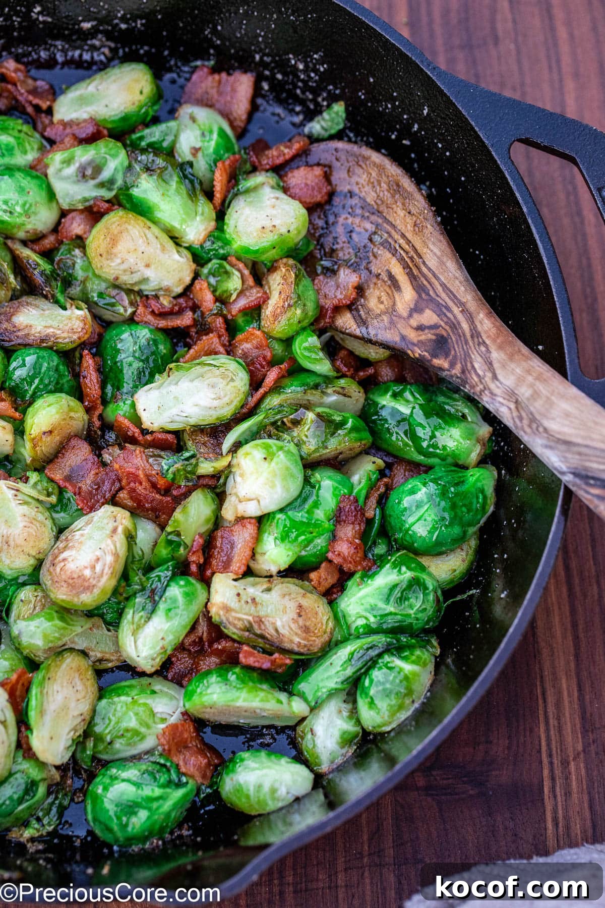 Crispy Pan-Fried Brussels Sprouts with Bacon and Garlic 10 Cooked bacon with Brussels sprouts in a skillet.