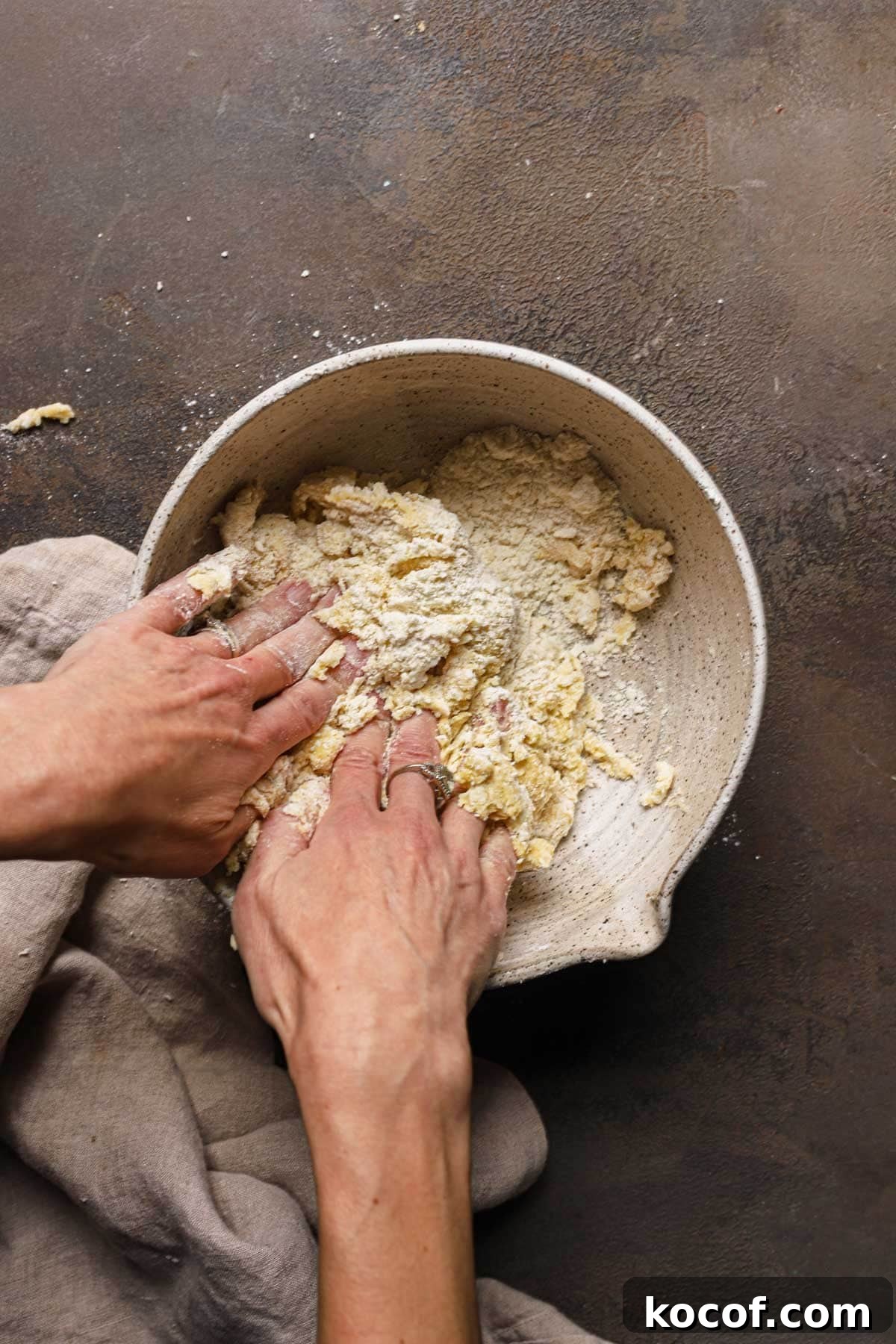 Italian Pasta Frolla Shortcrust Recipe for Tarts & Cookies 11 Hand bringing dough together in a large bowl.