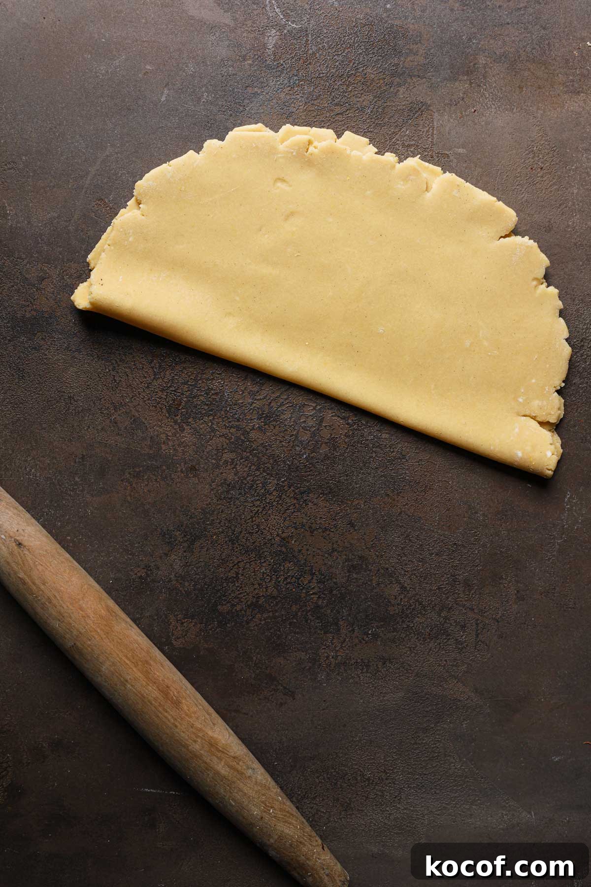 Italian Pasta Frolla Shortcrust Recipe for Tarts & Cookies 14 Rolled dough folded over itself next to a rolling pin.