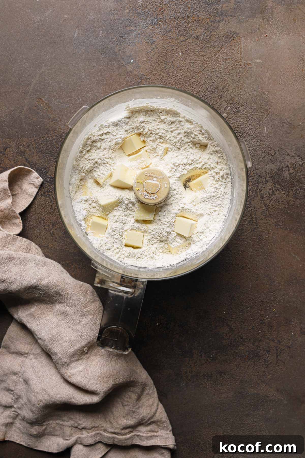 Italian Pasta Frolla Shortcrust Recipe for Tarts & Cookies 4 A food processor bowl with flour and pieces of butter.