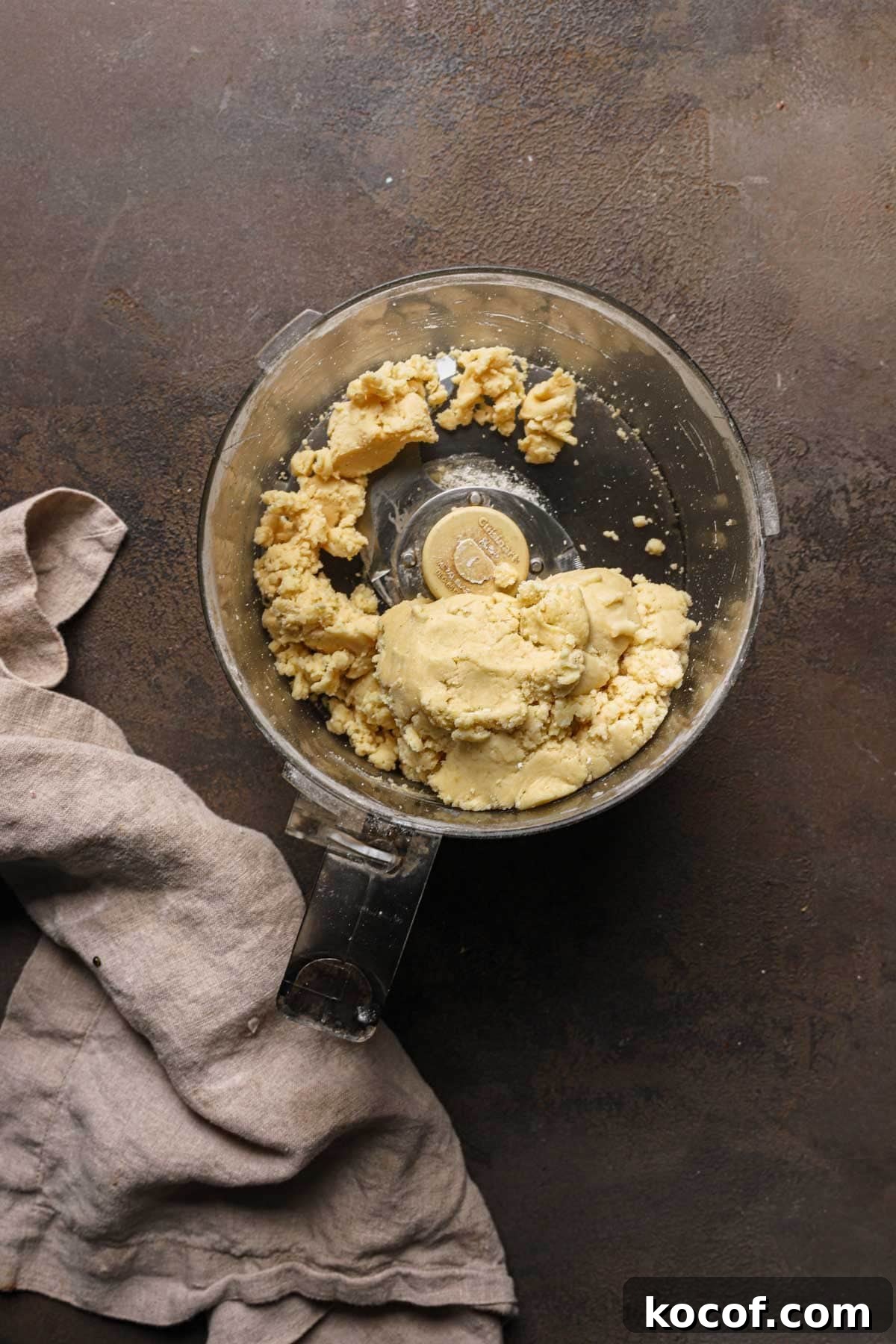 Italian Pasta Frolla Shortcrust Recipe for Tarts & Cookies 6 A food processor bowl with pasta frolla dough.