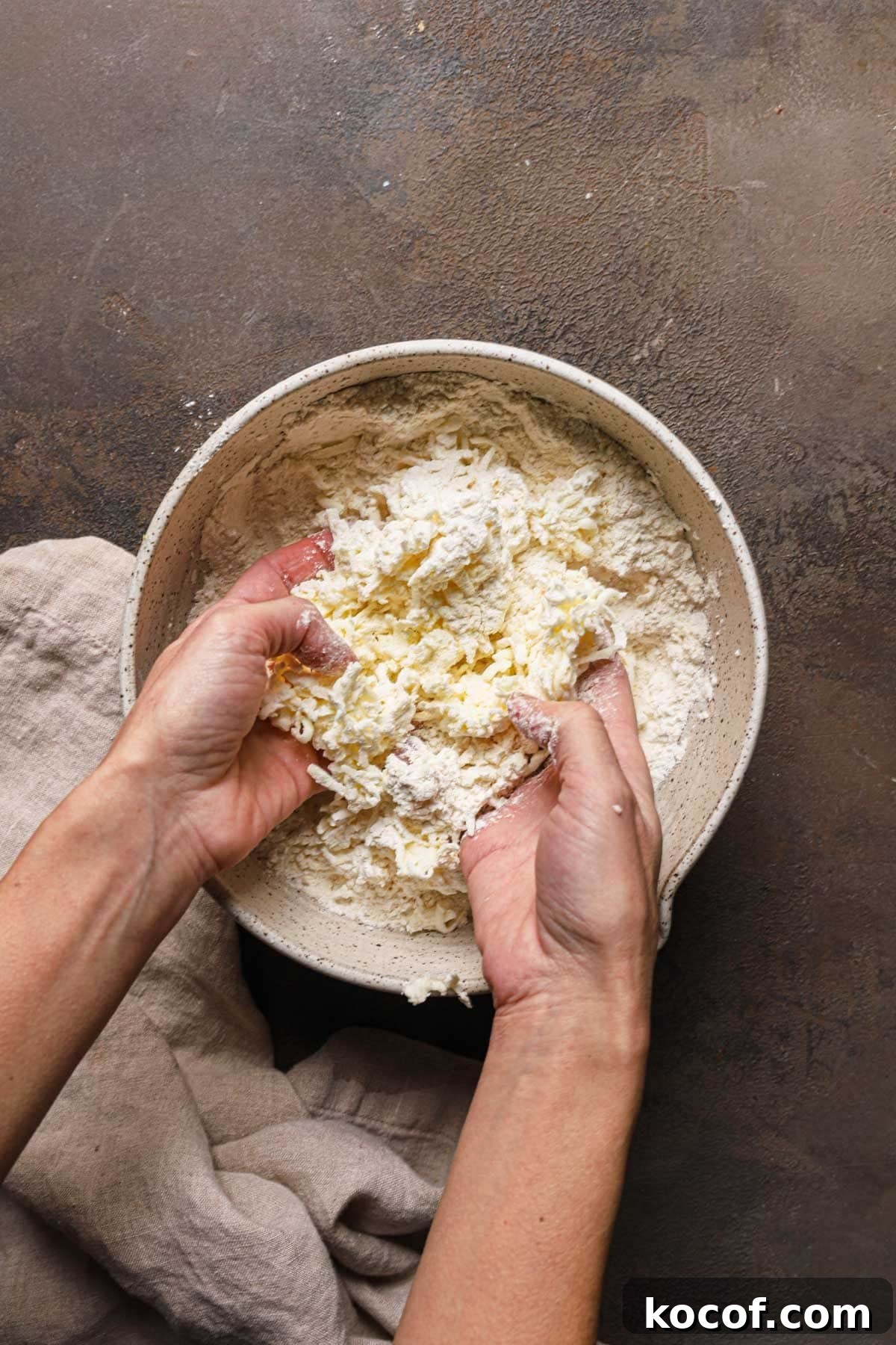 Italian Pasta Frolla Shortcrust Recipe for Tarts & Cookies 9 Hands rubbing butter into flour in a large bowl.