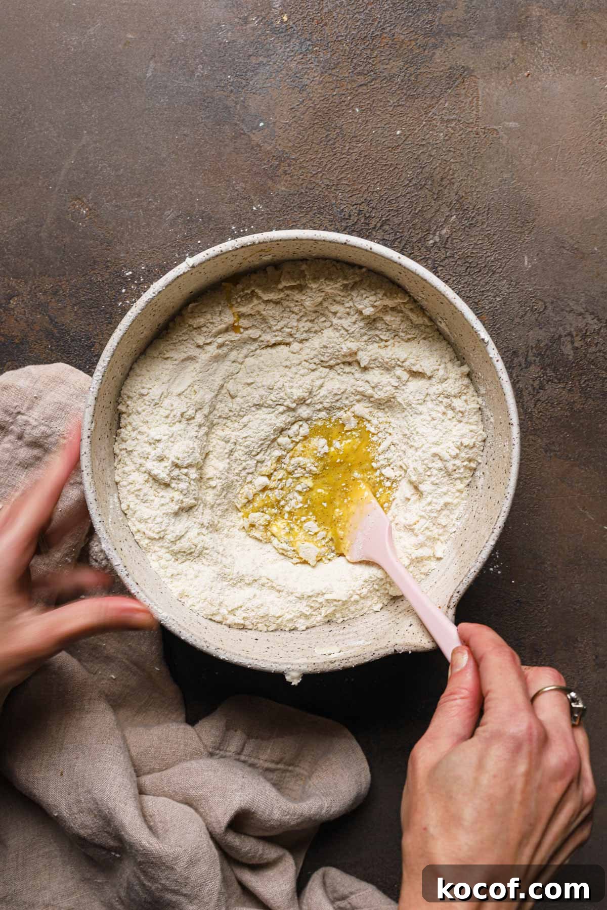 Italian Pasta Frolla Shortcrust Recipe for Tarts & Cookies 10 Hands mixing eggs into a large bowl with flour.