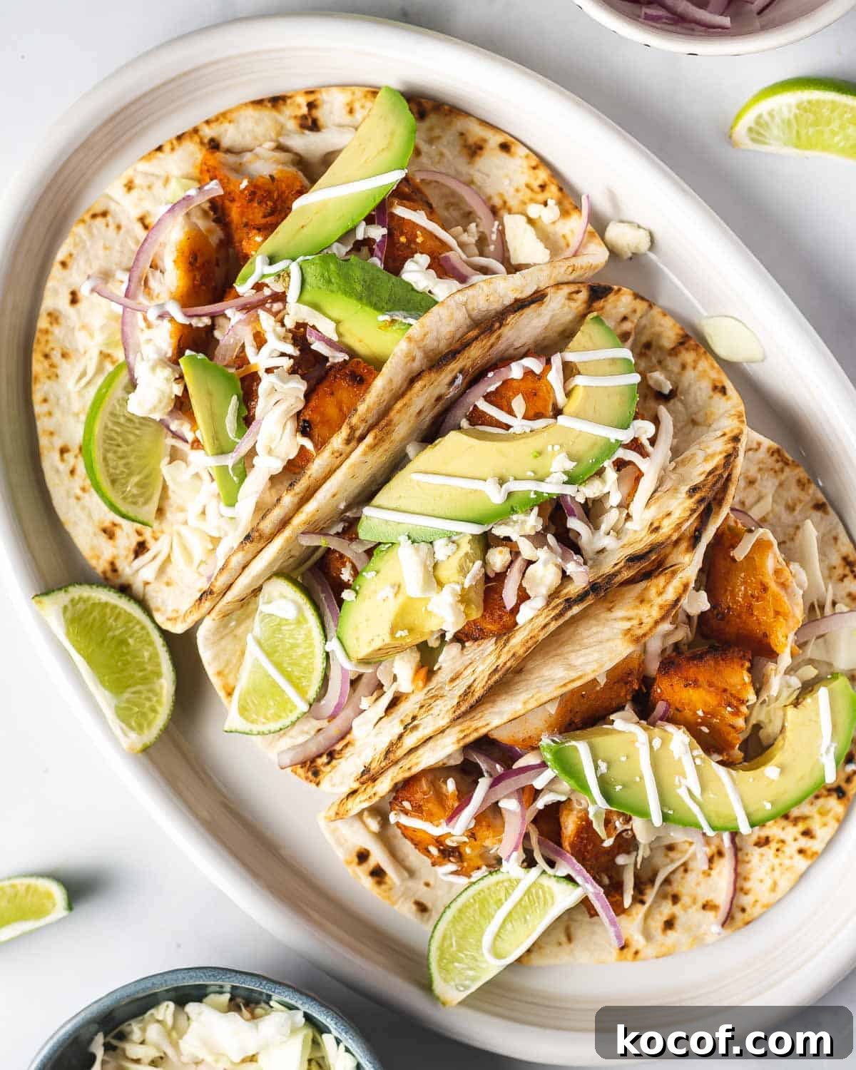 Close up of a platter of air fryer fish tacos with toppings.