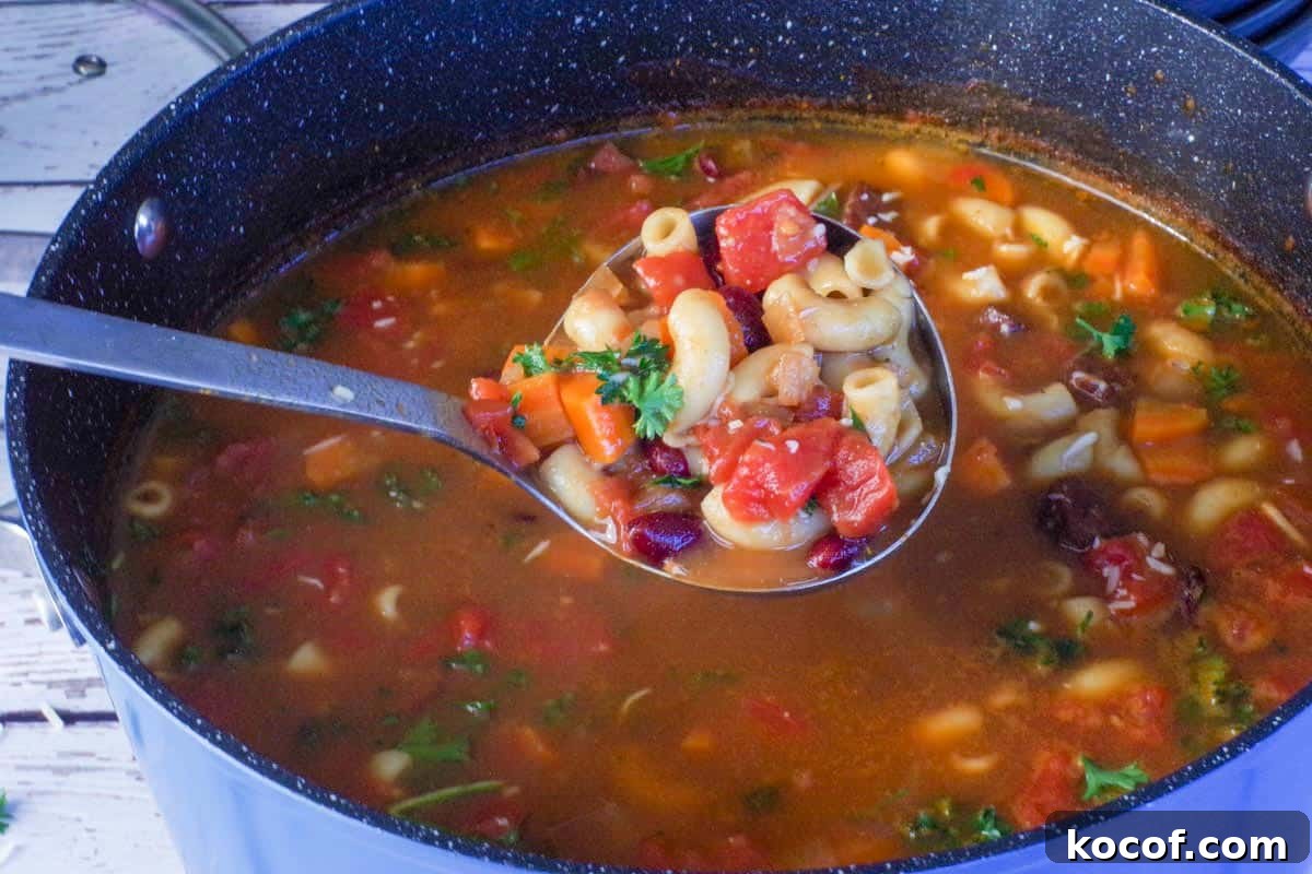 leftover ham macaroni soup being lifted out of pot with a ladle