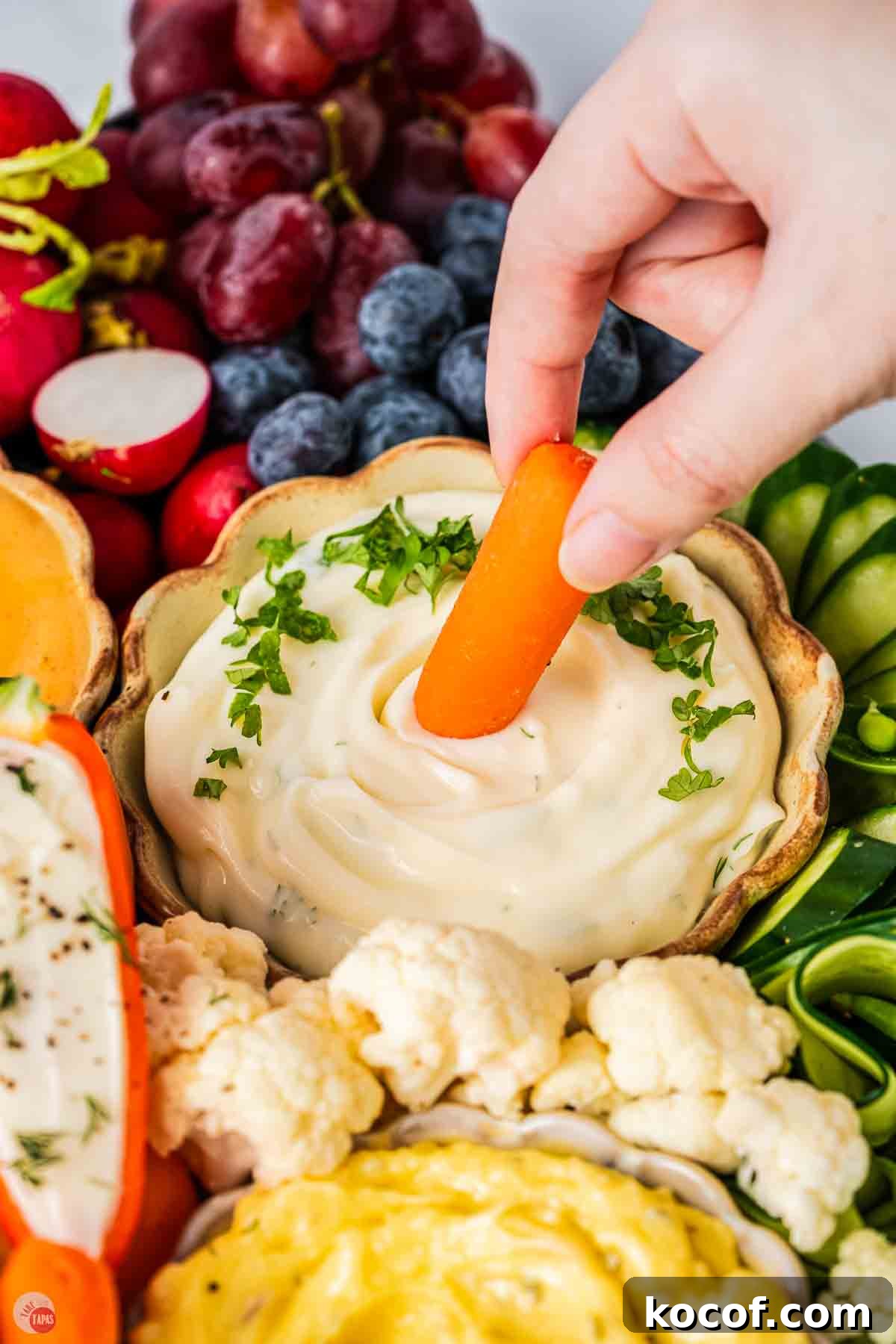 carrot stick dipping in a bowl of ranch dressing