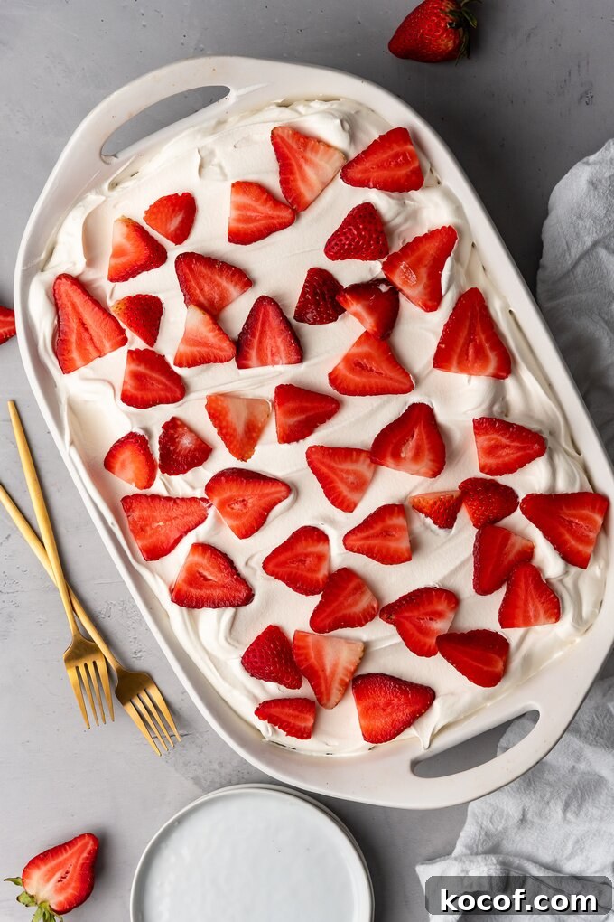 Moist Strawberry Poke Cake Recipe with Fresh Strawberry Filling 5 img 18725 10