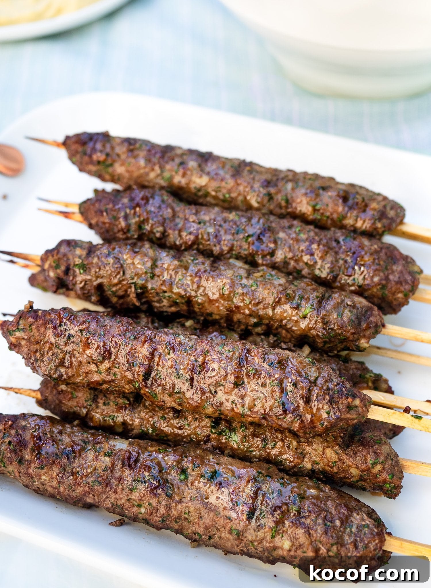 Authentic Kafta Kebab Recipe: Juicy Middle Eastern Grilled Skewers 2 Grilled Kafta Kebabs on platter.