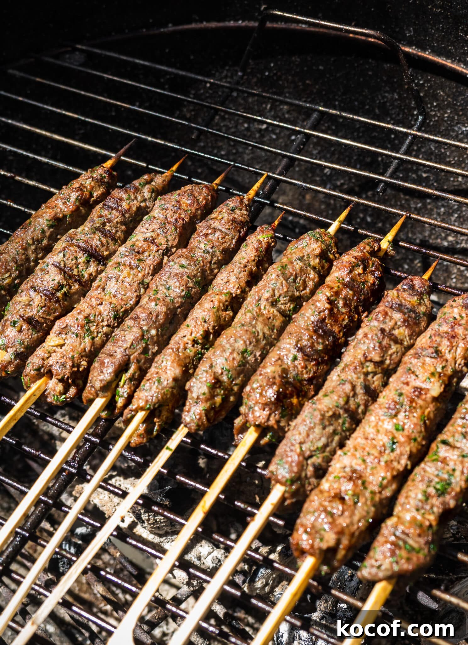 Authentic Kafta Kebab Recipe: Juicy Middle Eastern Grilled Skewers 5 Kafta kebabs on the grill.