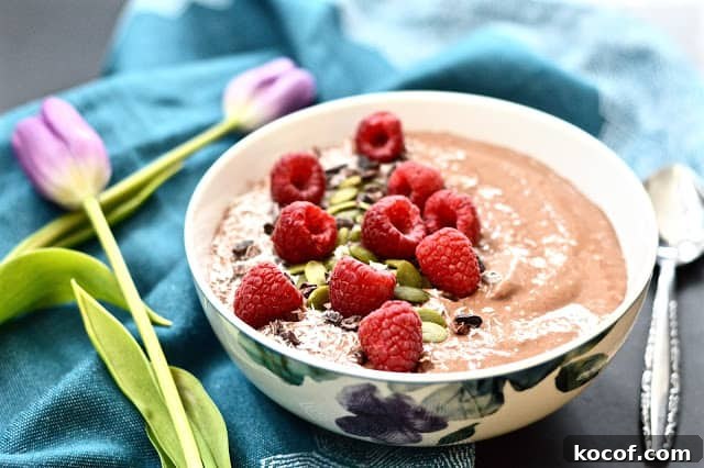 Chocolate Raspberry Smoothie Bowl Recipe for a Creamy Breakfast 2 A chocolate raspberry smoothie bowl topped with shredded coconut, cacao nibs and fresh raspberries.