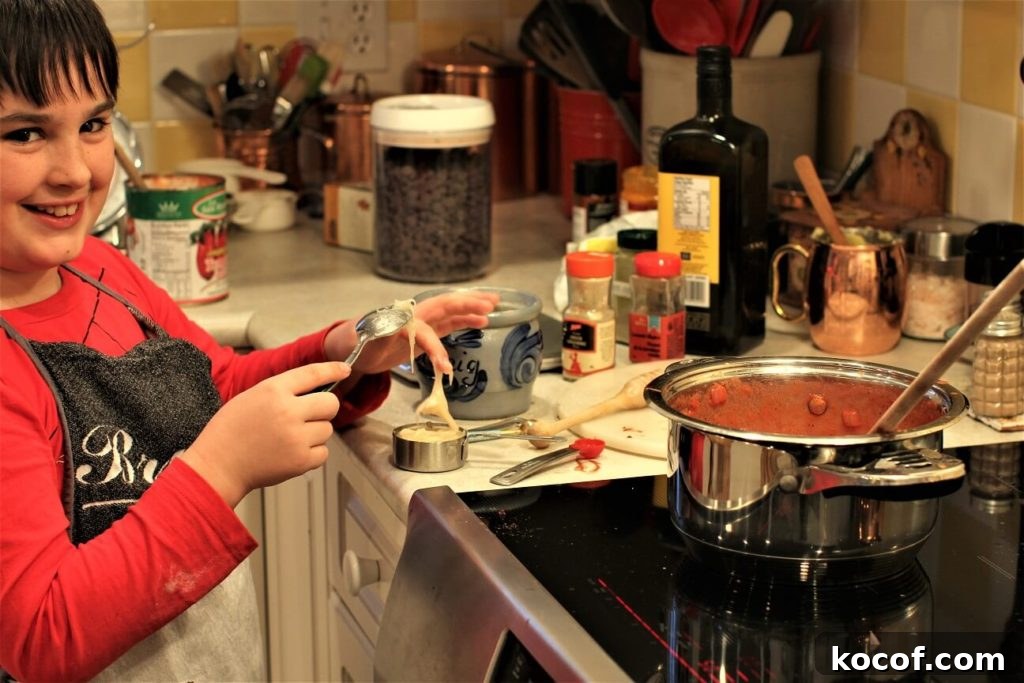 Make Ketchup at Home with Kids: Fun Family Recipe Tutorial 4 scraping the honey into the pot for homemade ketchup