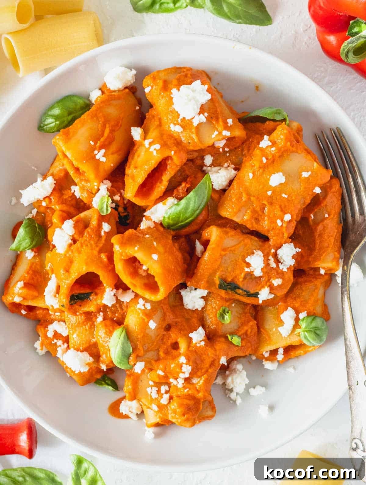 Delicious Vegan Pasta Recipes for Quick Weeknight Dinners 2 High protein pasta with feta crumble and fresh basil leaves in a white bowl