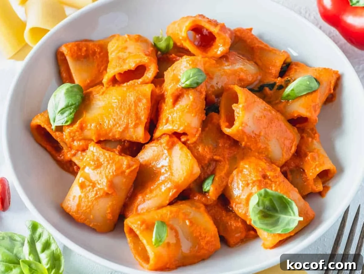 Delicious Vegan Pasta Recipes for Quick Weeknight Dinners 3 high protein pasta on a white plate with fresh basil leaves