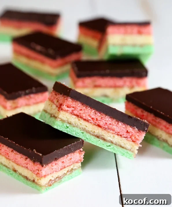 Gluten-Free Rainbow Cookie Recipe for Vibrant Layered Cookies 2 A close up of rainbow cookies on white surface .