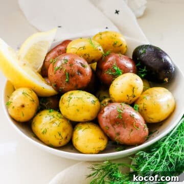 potato medley in a white bowl with lemon wedges on the side and fresh dill.