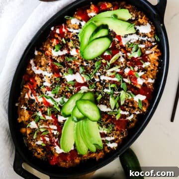 salmon sushi bake with fresh avocado and cucumbers on top.