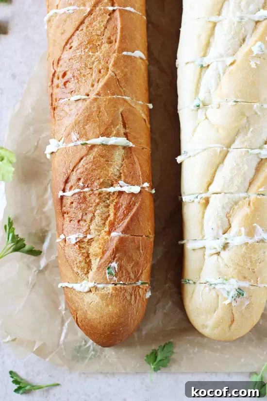 Easy, fast and delicious homemade freezer garlic bread! Have this crispy, herby and buttery bread ready to go whenever you need it! Two loaves of bread partially sliced and smeared with garlic butter.