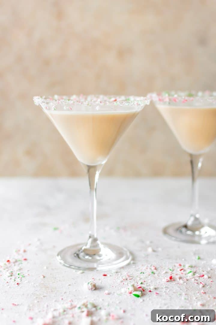 Chocolate Peppermint Martini with Crushed Candy Cane Rim 3 two martini glasses of creamy festive holiday cocktail and red and green crushed candy cane rims