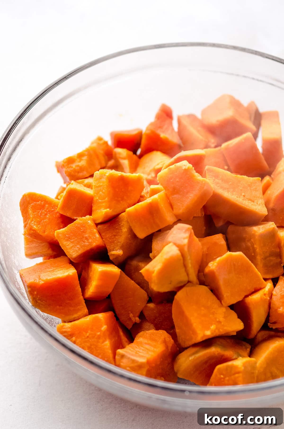 A bowl of cooked sweet potato cubes.