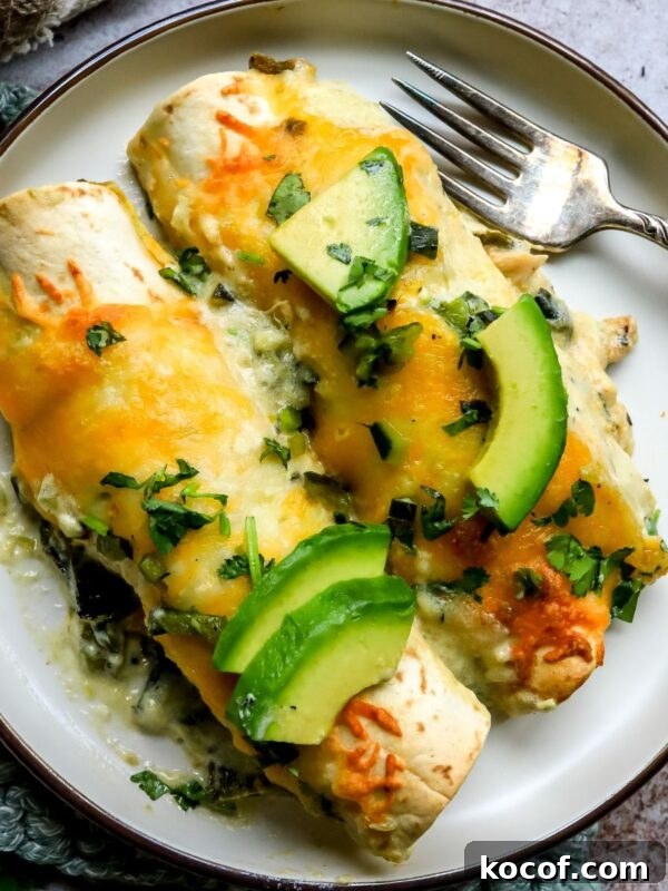 Perfect Blackened Steak Recipe for a Spicy, Crisp Crust 7 Poblano Chicken Enchiladas on a small plate with a silver fork to the side.