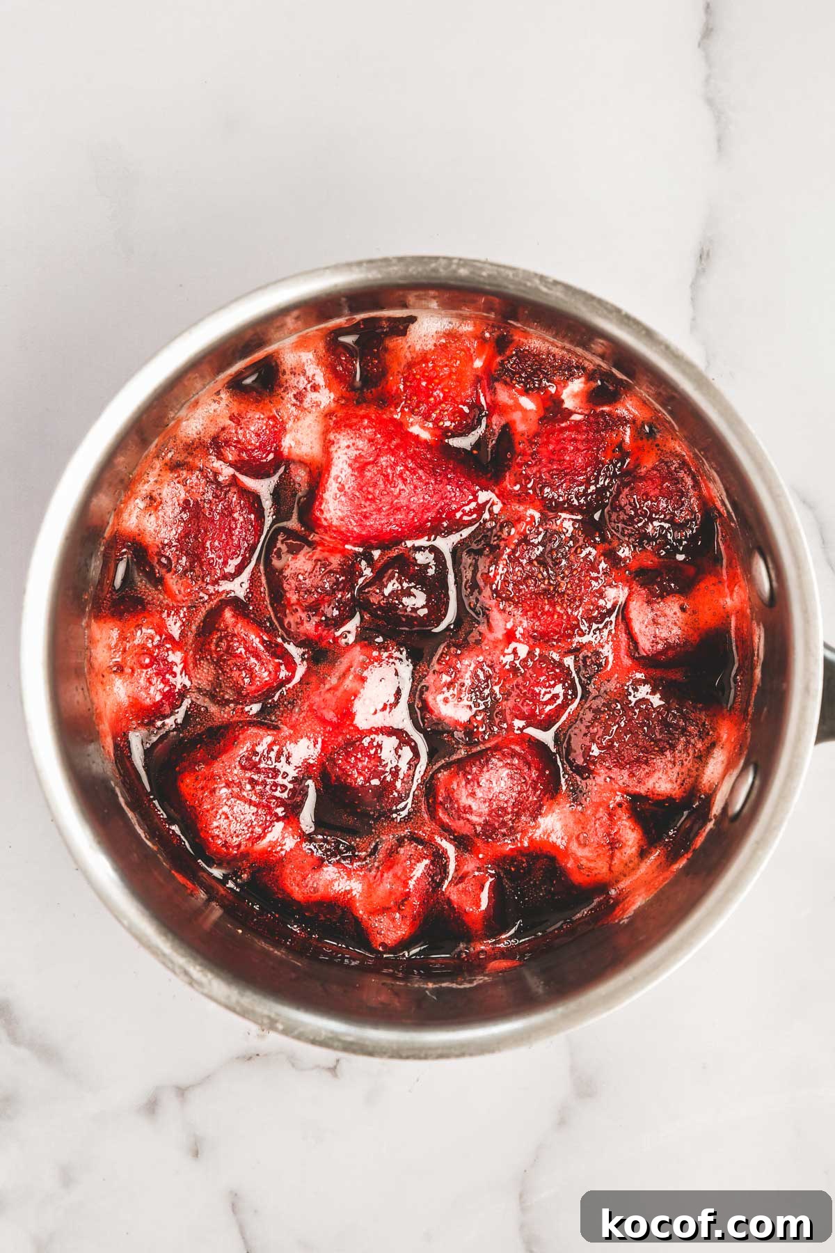 Decadent Chocolate Strawberry Cupcakes with Fresh Berry Frosting 6 homemade strawberry compote cooking in a saucepan