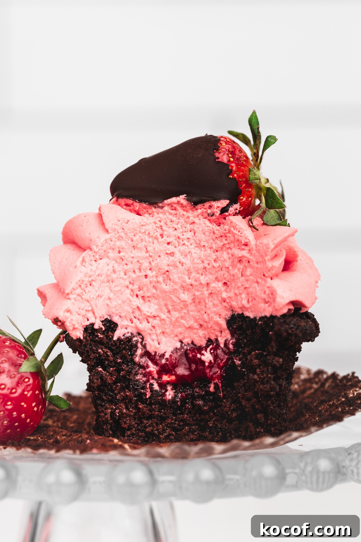 Decadent Chocolate Strawberry Cupcakes with Fresh Berry Frosting 9 chocolate strawberry cupcake cut in half with strawberry compote filling inside