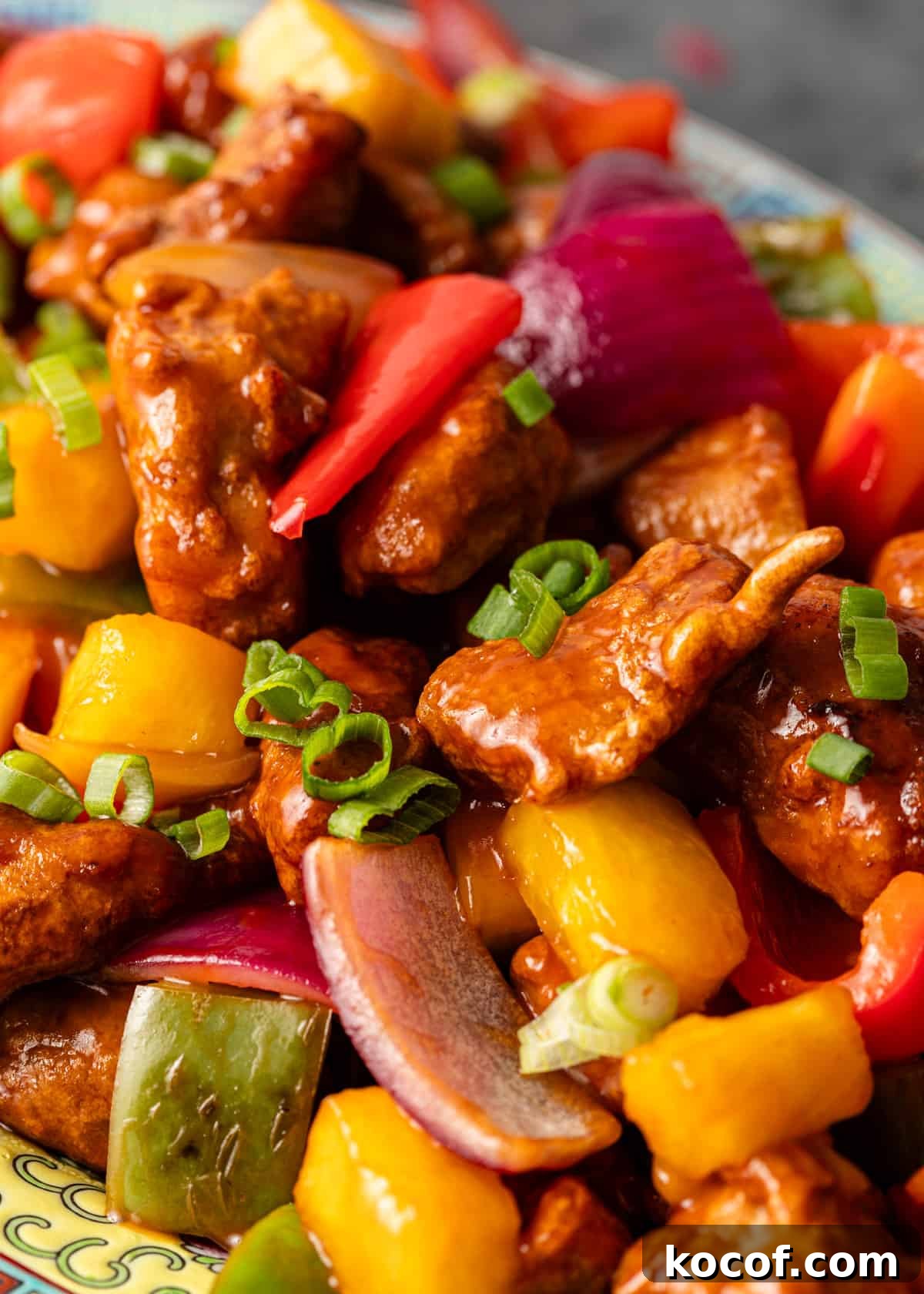 extreme closeup: sweet and sour pork with veggies showing