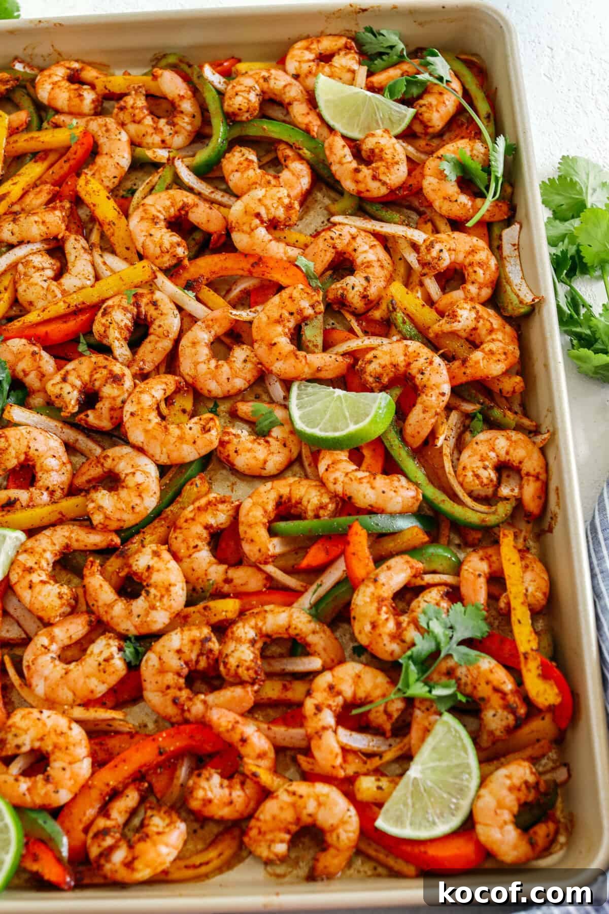 EASY Sheet Pan Shrimp Fajitas with all your favorite Mexican flavors that makes the perfect healthy weeknight dinner easily made all on one pan in under 20 minutes!  Perfect recipe for your Sunday meal prep too!  