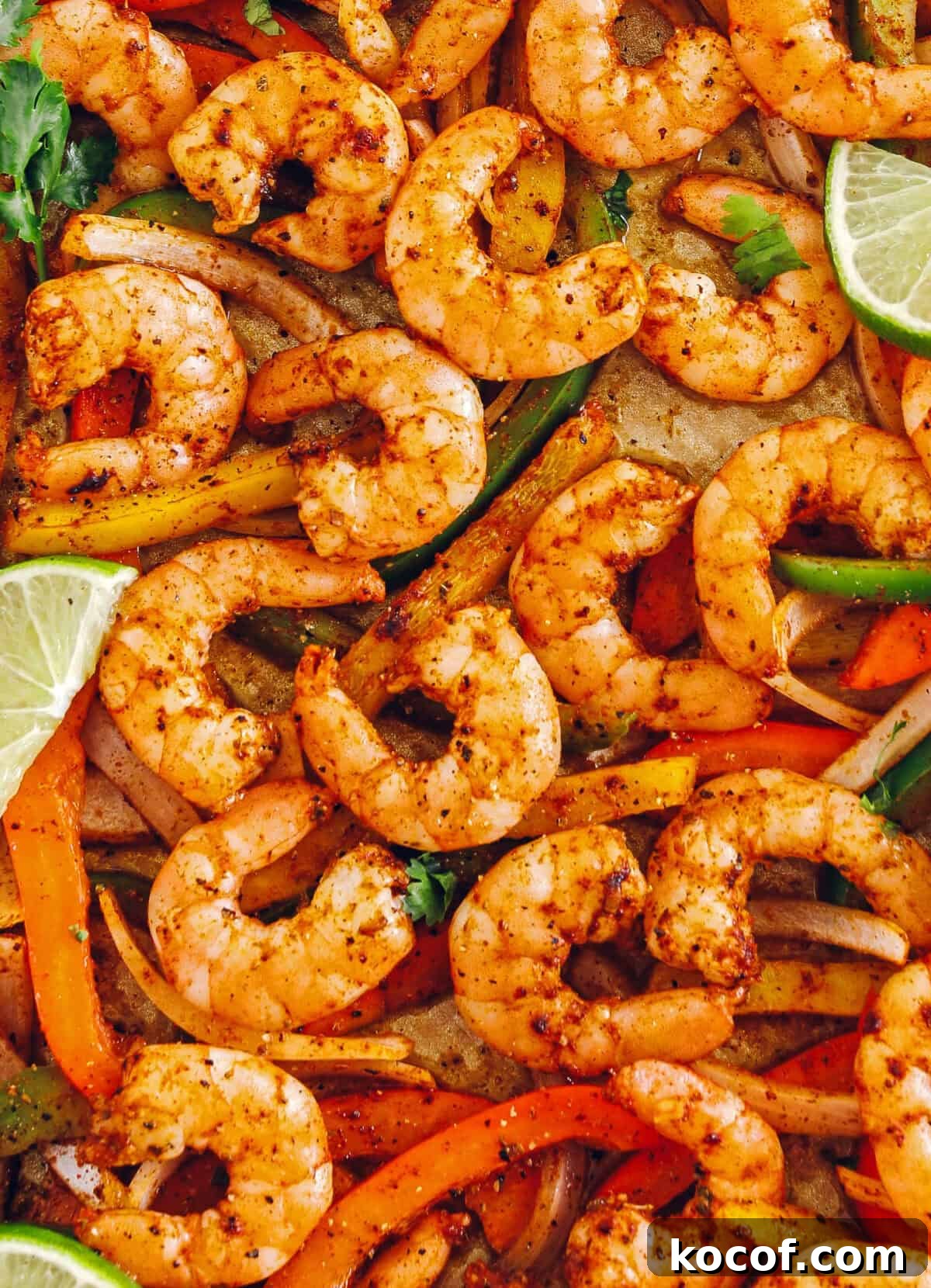 EASY Sheet Pan Shrimp Fajitas with all your favorite Mexican flavors that makes the perfect healthy weeknight dinner easily made all on one pan in under 20 minutes!  Perfect recipe for your Sunday meal prep too!  