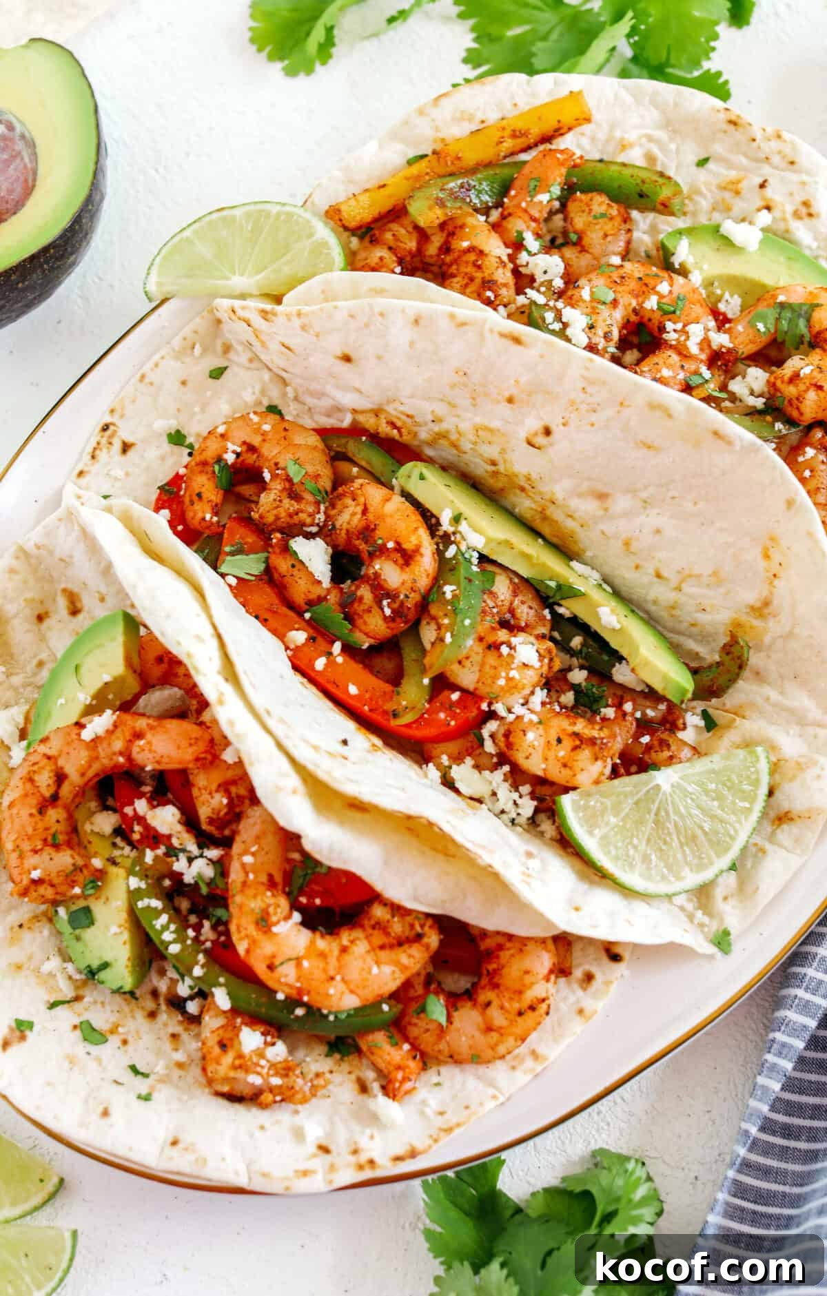 EASY Sheet Pan Shrimp Fajitas with all your favorite Mexican flavors that makes the perfect healthy weeknight dinner easily made all on one pan in under 20 minutes!  Perfect recipe for your Sunday meal prep too!  