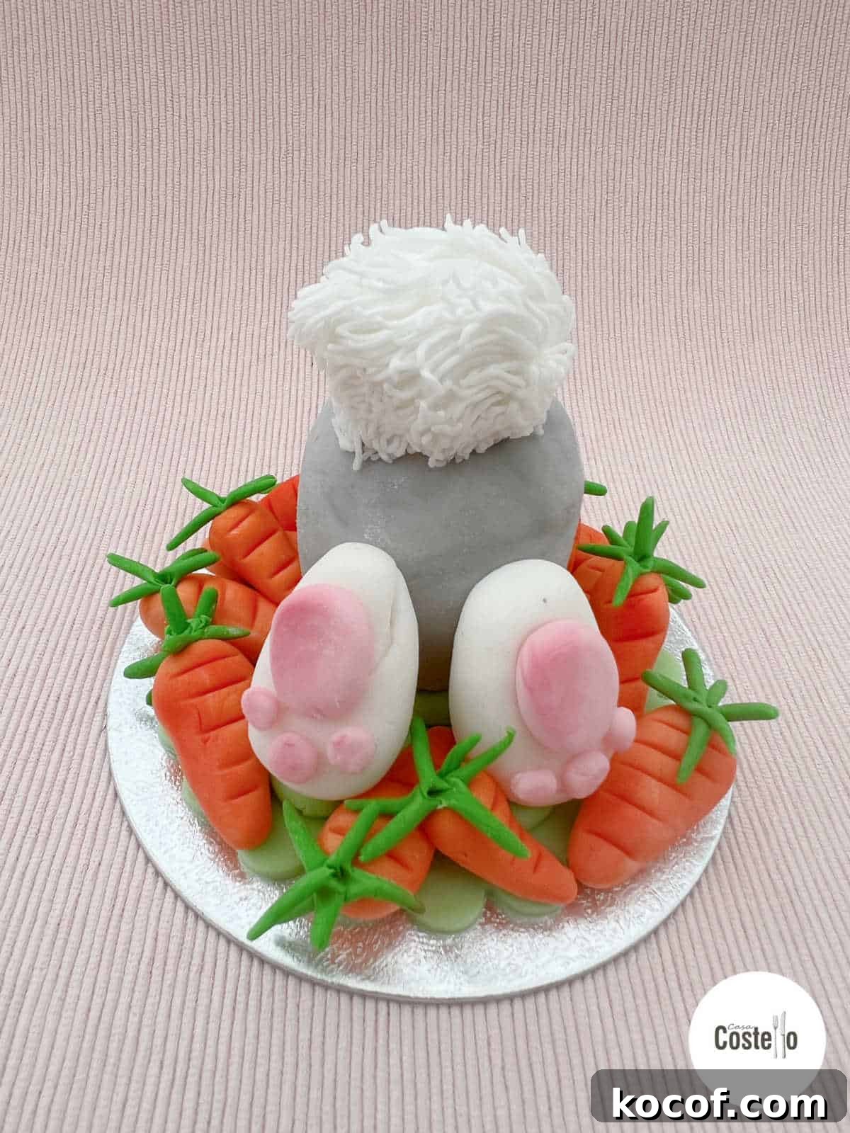 Creme Egg Easter Bunny Cake Recipe: Fun Step-by-Step Guide 3 Creme Egg Bunny with bunny feet and white bobtail in a bed of sugar carrots