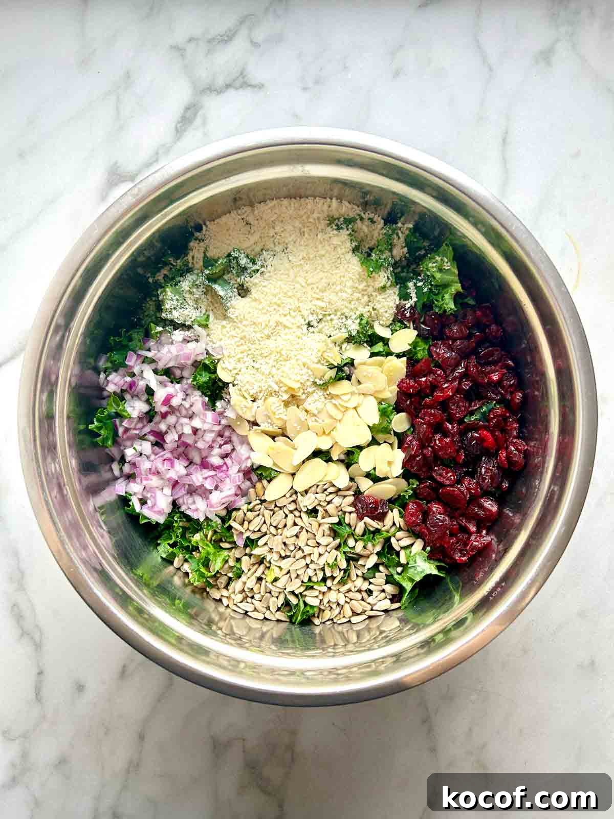 kale salad components arranged in a bowl.
