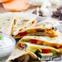 Slices of a veggie quesadilla fanned out on a plate.