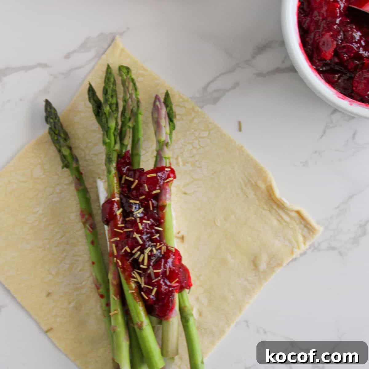 Crispy Puff Pastry-Wrapped Asparagus Recipe 5 Asparagus, brie and cranberry jam on puff pastry.