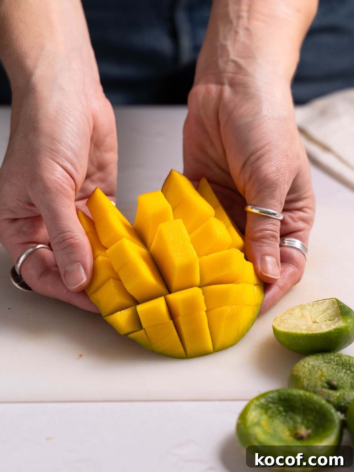 Fanning out pieces of mango, chopped from the skin
