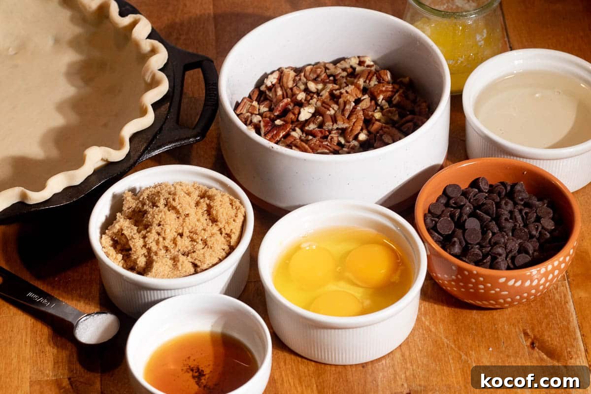 Chocolate Chip Pecan Pie Recipe with Gooey Chocolate Filling 4 Ingredients for chocolate chip pecan pie including pecans, chocolate chips, eggs, brown sugar, butter, and pie crust.