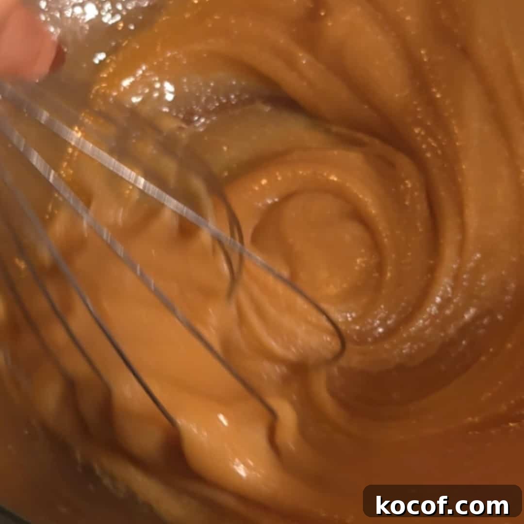 Chocolate Chip Pecan Pie Recipe with Gooey Chocolate Filling 7 Whisking together brown sugar, butter, and corn syrup to create the smooth filling for chocolate chip pecan pie.