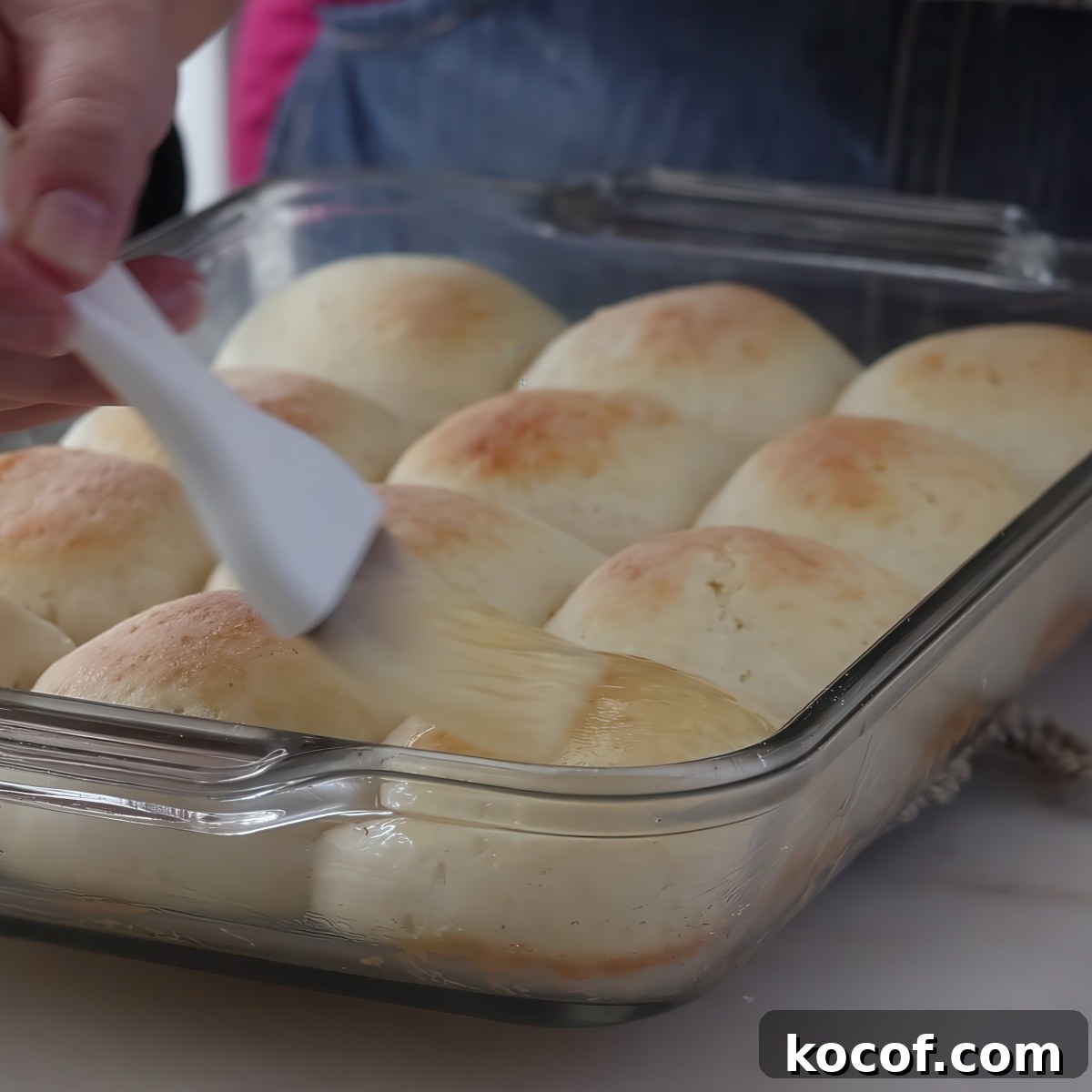 brushing baked rolls with butter.