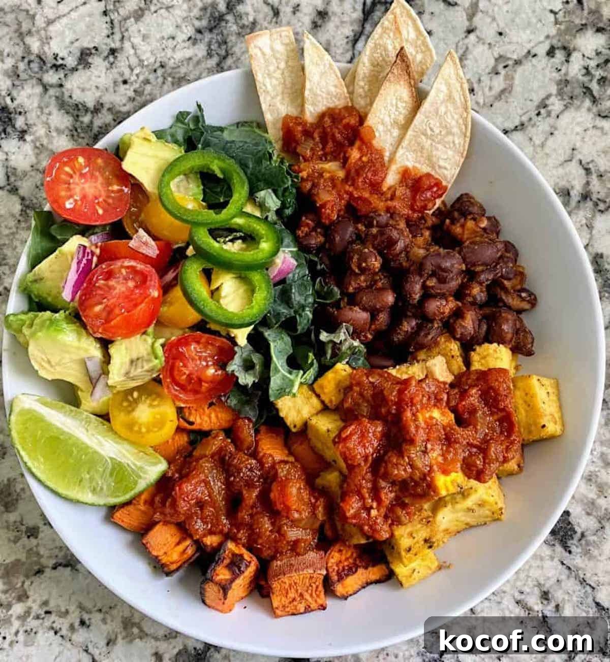 Hearty Vegan Breakfast Bowl with Quinoa, Avocado & Tofu 7 Vegan breakfast bowl on the table.