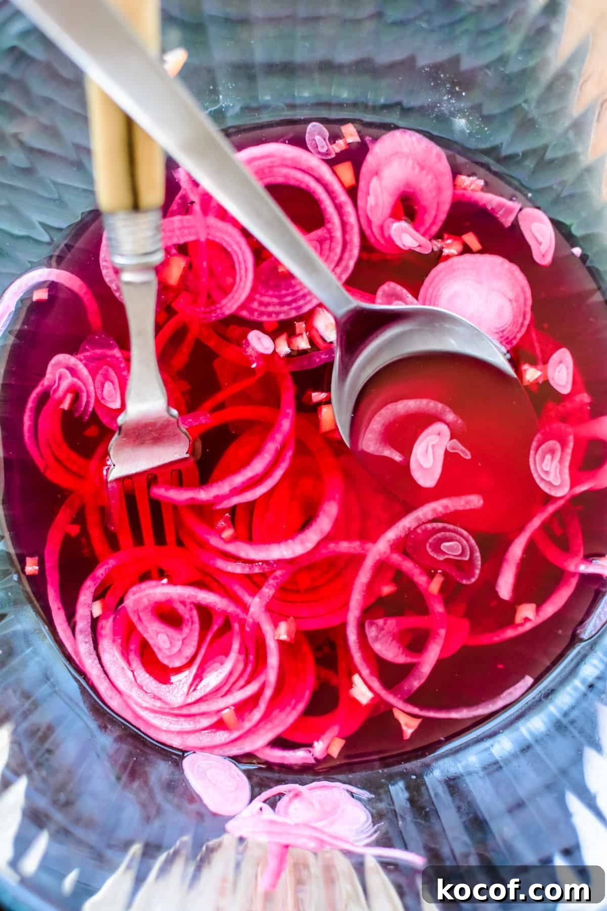 22 Delicious Easter Dinner Ideas That Aren’t Ham 14 A bowl of pickled red onions with a fork and a spoon sticking into the bowl.