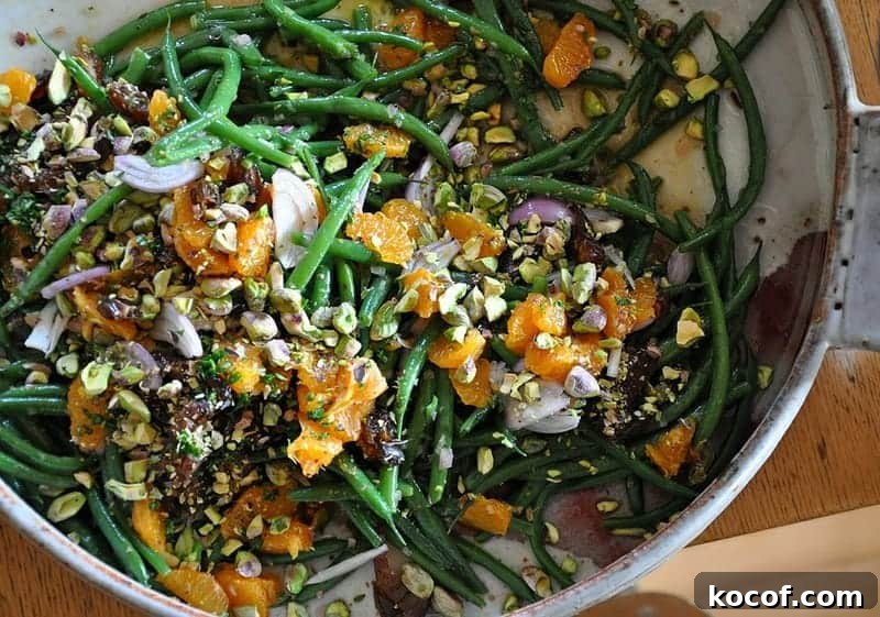22 Delicious Easter Dinner Ideas That Aren’t Ham 16 A ceramic dish filled with green beans tossed with tangerines, shallots, pistachios, dates.