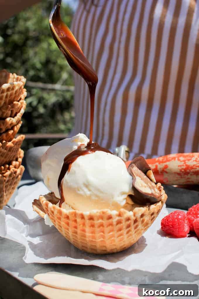 22 Delicious Easter Dinner Ideas That Aren’t Ham 21 Two scoops of vanilla ice cream in a waffle dish with someone pouring caramel sauce from a spoon over the top.