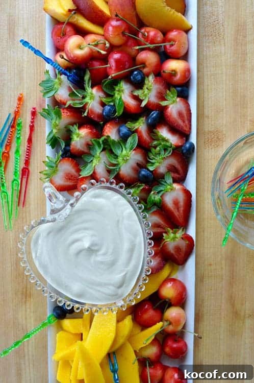 22 Delicious Easter Dinner Ideas That Aren’t Ham 23 A tray of cut strawberries, blueberries, nectarines, mango slices, and cherries with a dish of creamy dip on one side.